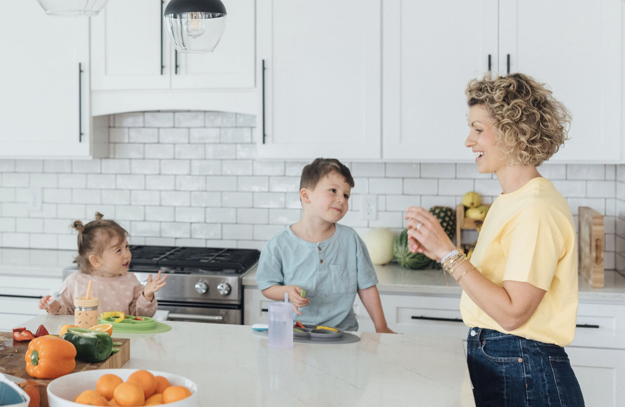 Eat Play Say Founder Jordyn with her two children in their kitchen.