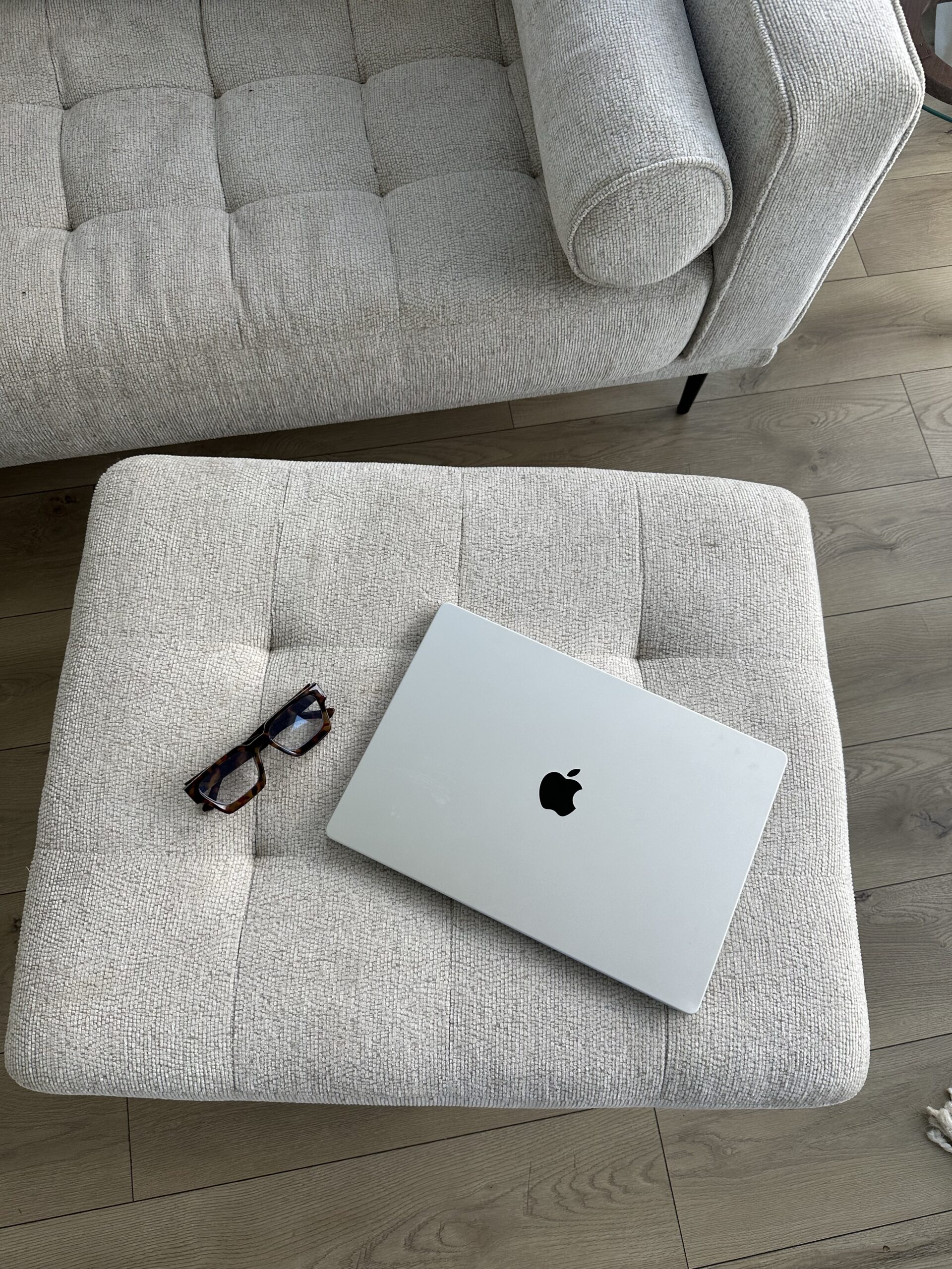 laptop and glasses sitting on a couch